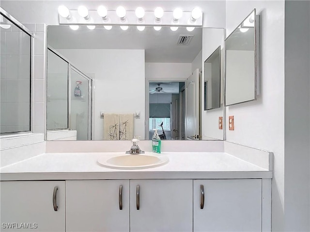 162 Newport Dr Unit 1202, Naples, FL 34114 - bathroom featuring a ceiling fan, a stall shower, and vanity