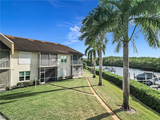 view of yard featuring a water view and a balcony