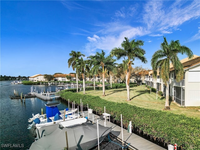 dock area featuring a water view and a lawn