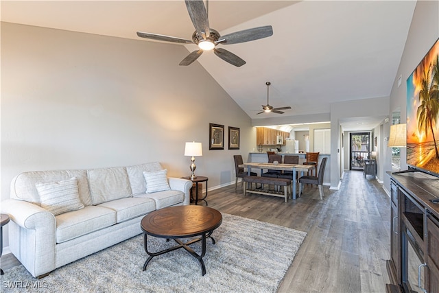 living room featuring ceiling fan, lofted ceiling, and hardwood / wood-style floors