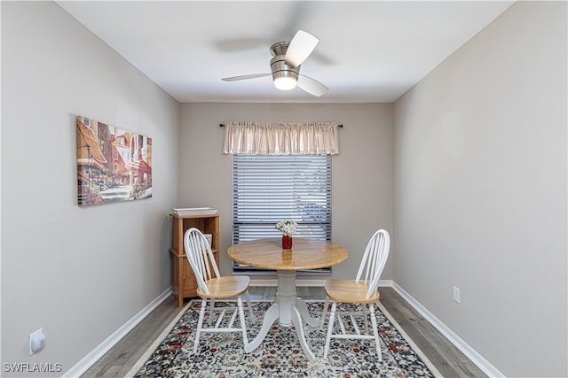 dining space with ceiling fan and wood-type flooring