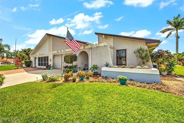 view of front facade featuring a garage and a front lawn