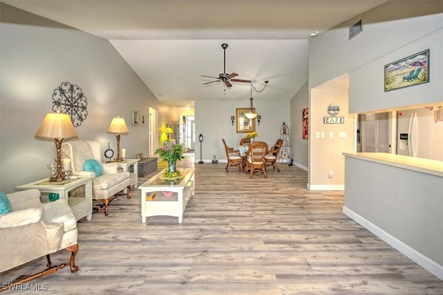 living room with light wood-type flooring, ceiling fan, and lofted ceiling