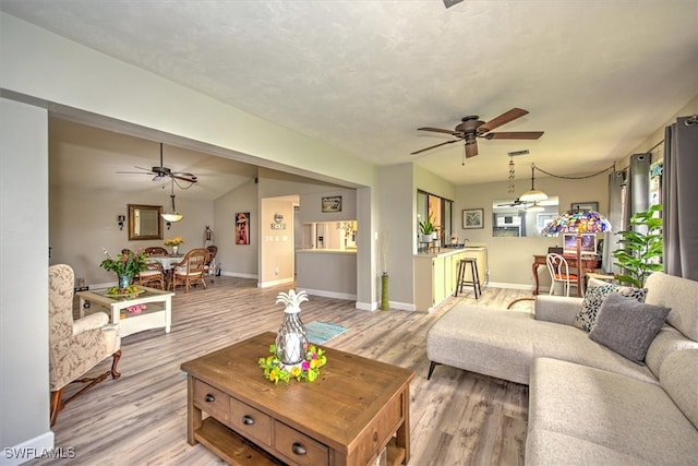 living room with hardwood / wood-style floors, plenty of natural light, and vaulted ceiling