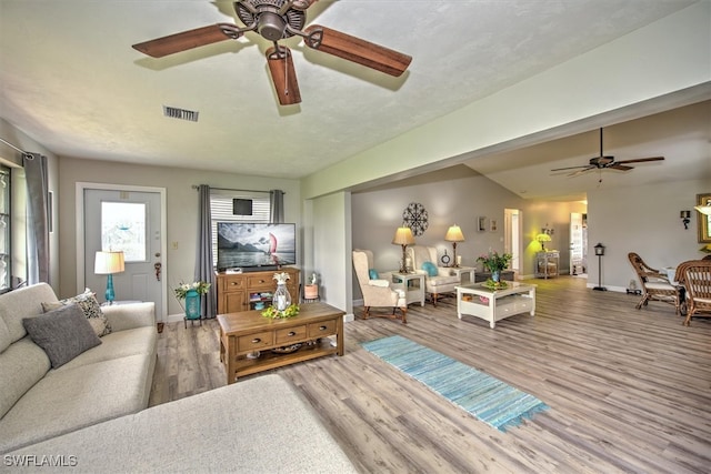 living room featuring hardwood / wood-style flooring and ceiling fan