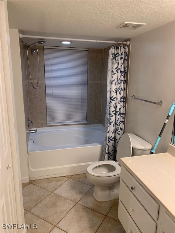 full bathroom featuring vanity, toilet, shower / bathtub combination with curtain, and a textured ceiling