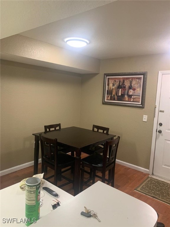 dining space featuring dark wood-type flooring