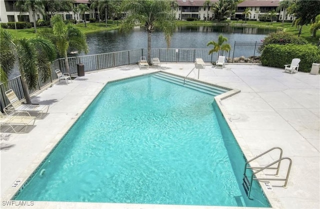 view of pool featuring a water view and a patio area