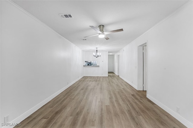 unfurnished living room featuring ceiling fan with notable chandelier, ornamental molding, and light hardwood / wood-style floors