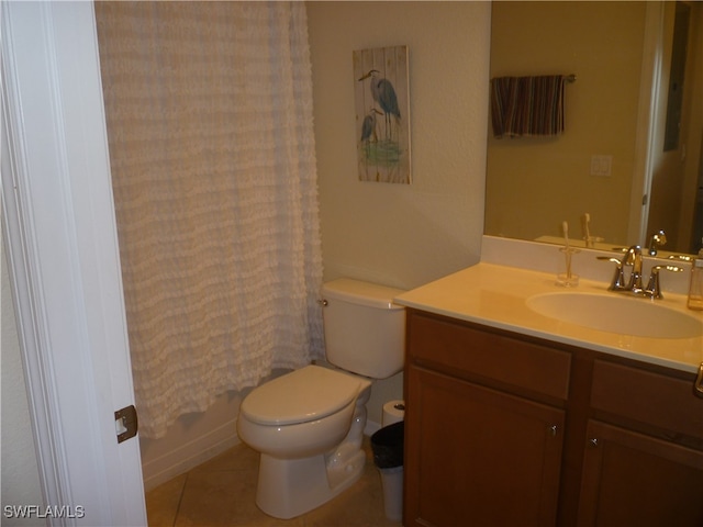 bathroom featuring toilet, vanity, and tile patterned flooring