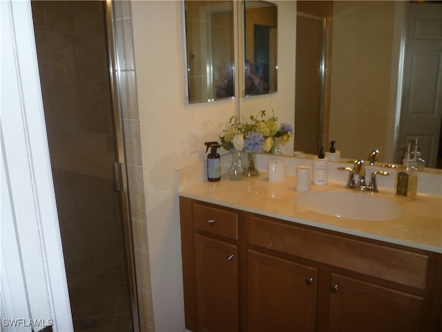 bathroom with vanity and a shower with shower door