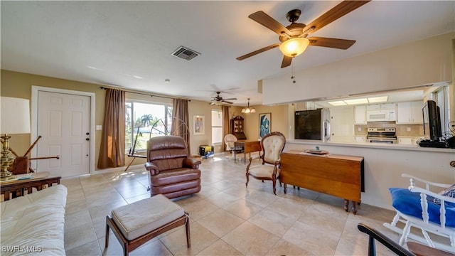 living room with ceiling fan and light tile patterned floors