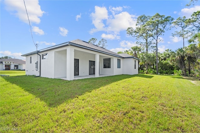 rear view of house with a yard