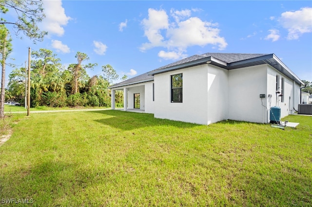 rear view of property with a yard