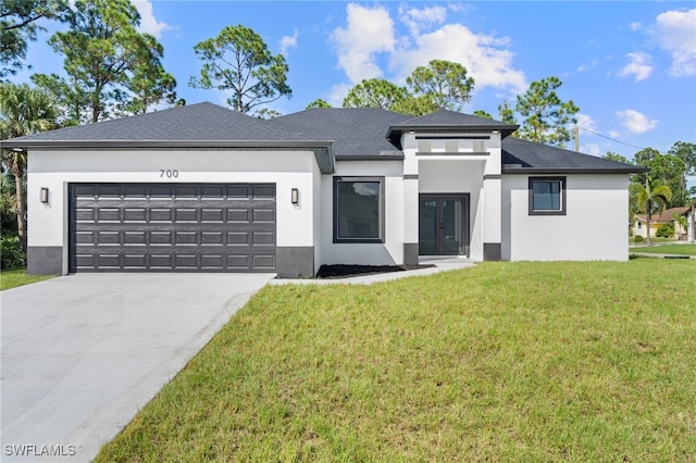 view of front of property featuring a front yard and a garage