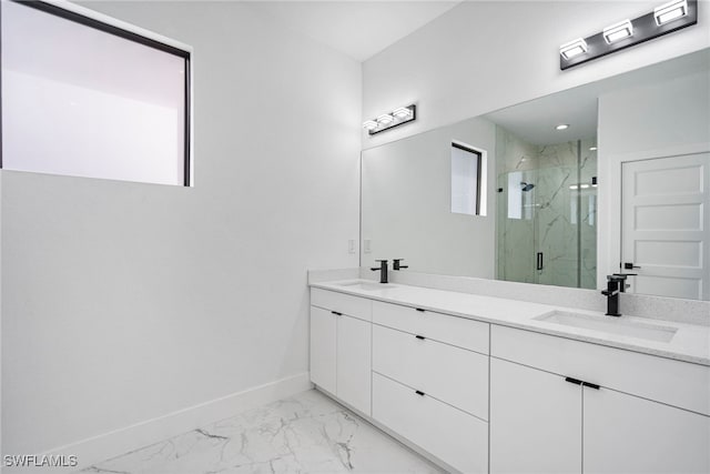 bathroom featuring a shower with door and vanity