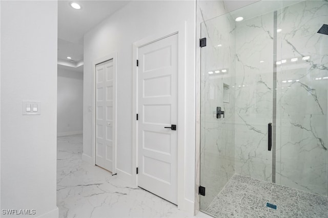 bathroom featuring a shower with door