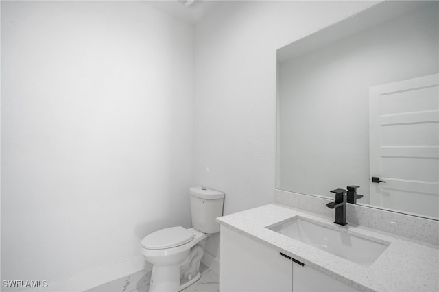 bathroom featuring toilet and vanity