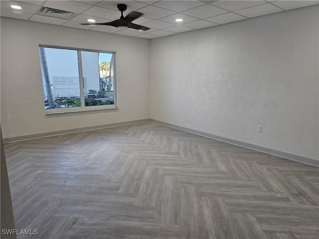 empty room featuring parquet floors and ceiling fan