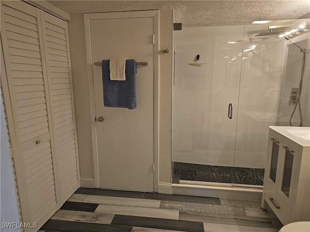 bathroom with vanity, wood-type flooring, and walk in shower