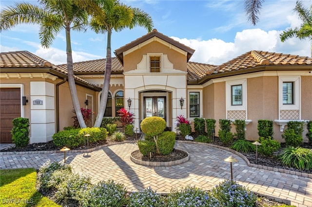 mediterranean / spanish-style home featuring a garage