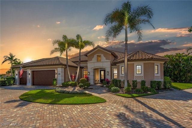 mediterranean / spanish-style house with a garage