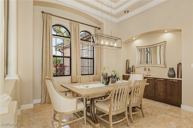 dining space featuring ornate columns, ornamental molding, and light tile patterned floors