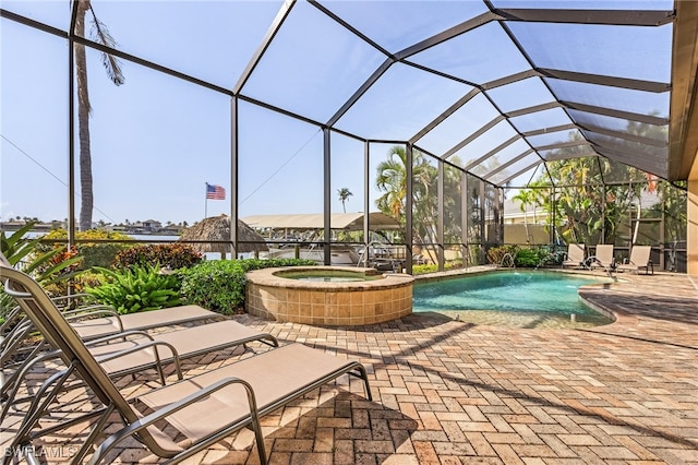 view of swimming pool featuring a patio area, a lanai, and an in ground hot tub