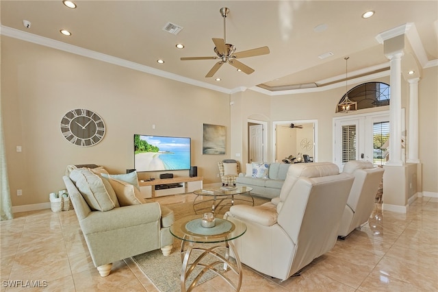 living room featuring a high ceiling, french doors, ornamental molding, decorative columns, and ceiling fan