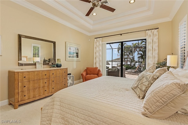 carpeted bedroom with ceiling fan, a raised ceiling, ornamental molding, and access to exterior