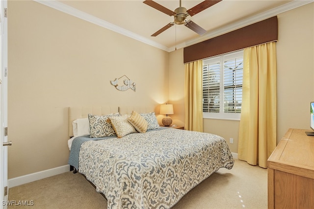 carpeted bedroom featuring ceiling fan and ornamental molding