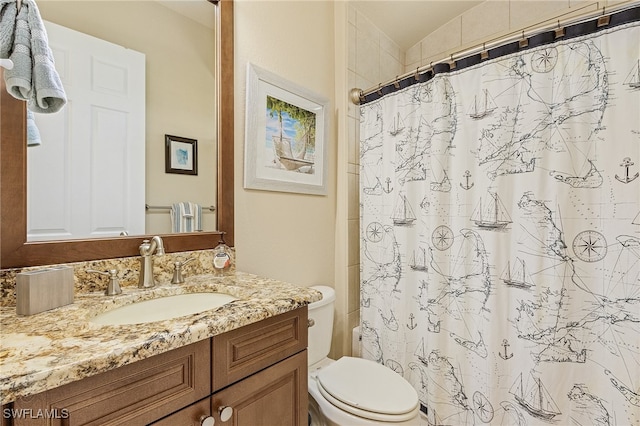 bathroom featuring vanity, toilet, and a shower with shower curtain