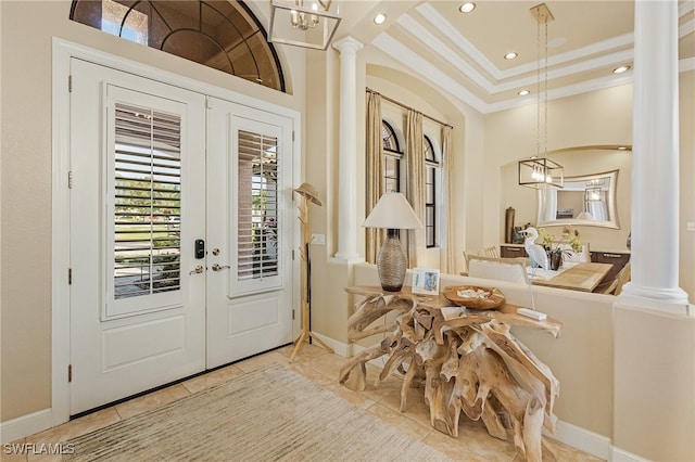 tiled entrance foyer with french doors, ornate columns, and crown molding