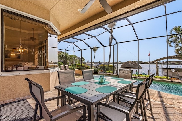 view of patio / terrace with ceiling fan and a lanai