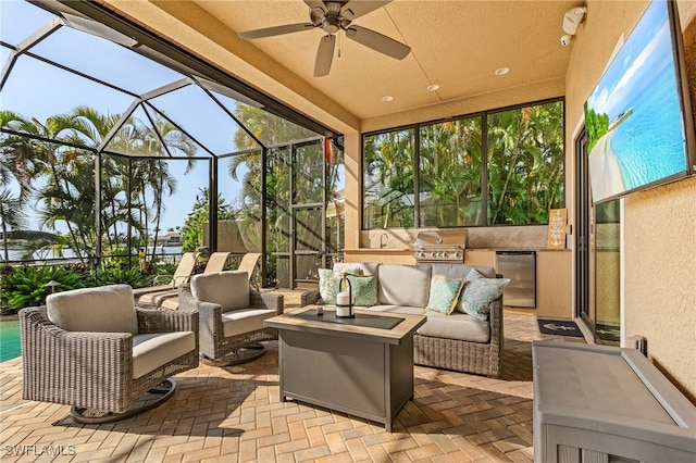 view of patio / terrace featuring area for grilling, glass enclosure, ceiling fan, an outdoor living space, and a grill