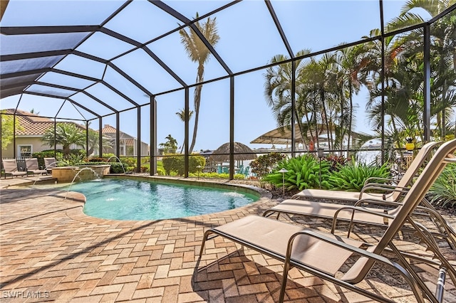 view of swimming pool with a lanai, a patio area, and pool water feature