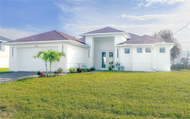 view of front of house featuring a garage and a front lawn