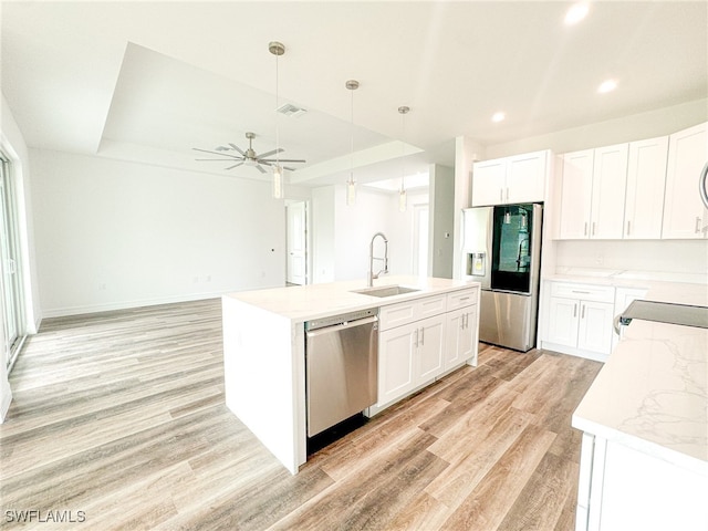 kitchen featuring white cabinetry, stainless steel appliances, sink, and pendant lighting