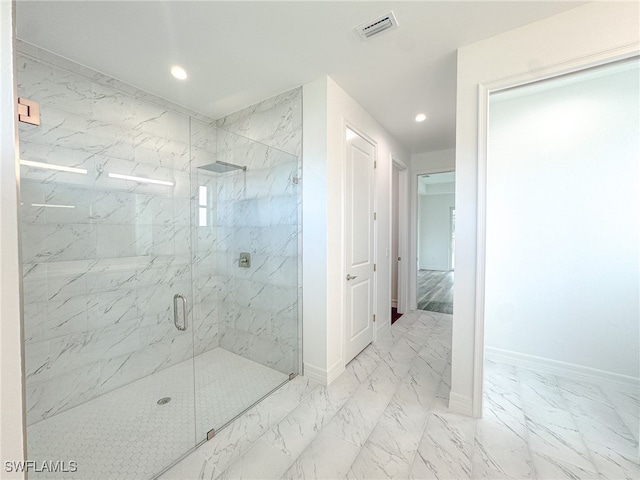 bathroom with a shower with door