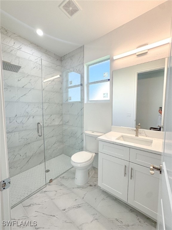 bathroom with vanity, walk in shower, and toilet