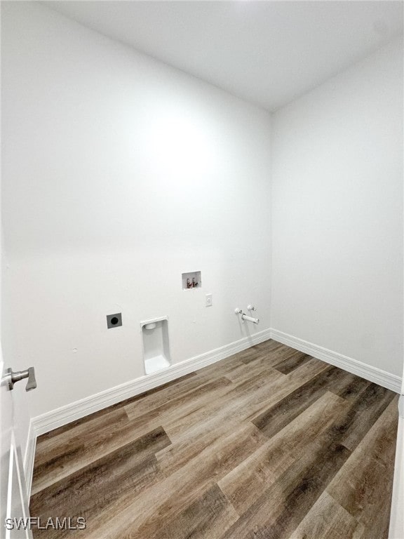 washroom with hookup for a gas dryer, electric dryer hookup, hookup for a washing machine, and wood-type flooring