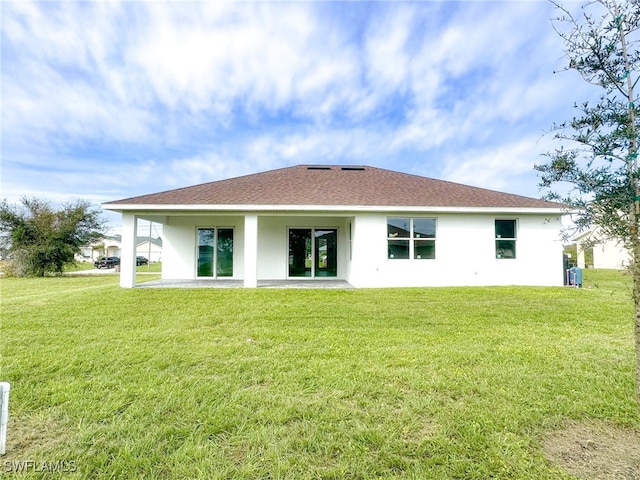 back of house with a patio and a yard