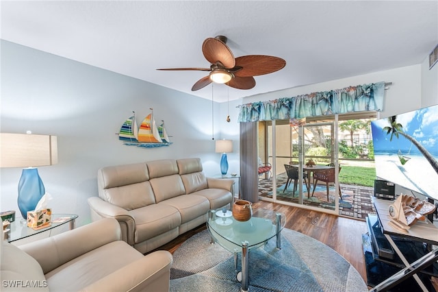 living room with wood-type flooring and ceiling fan