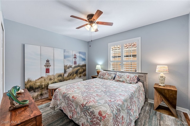 bedroom featuring dark hardwood / wood-style flooring and ceiling fan