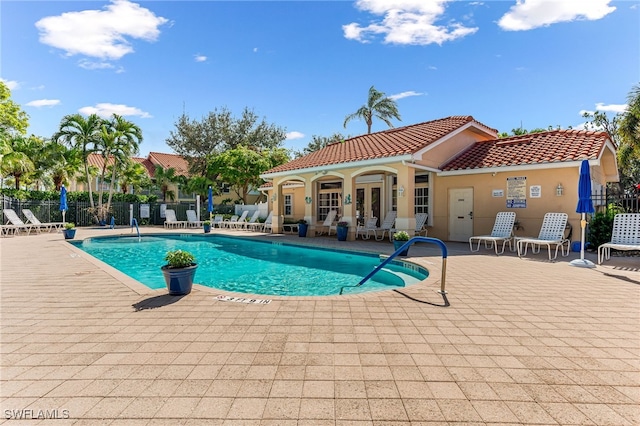 view of swimming pool with a patio and french doors