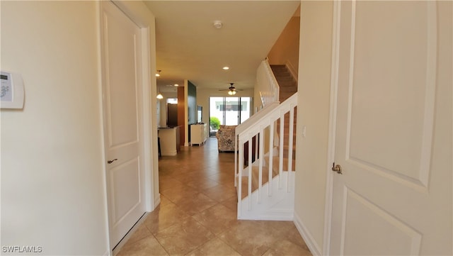 hall featuring light tile patterned floors