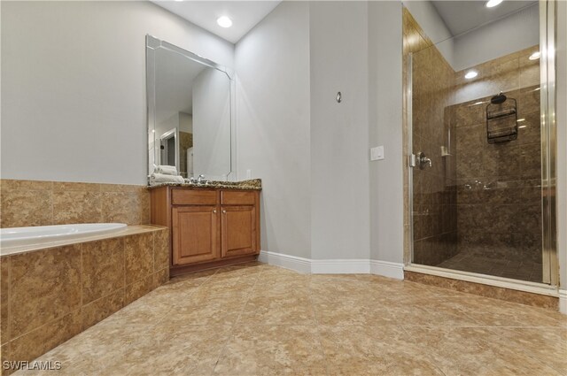 bathroom with vanity, shower with separate bathtub, and tile patterned floors