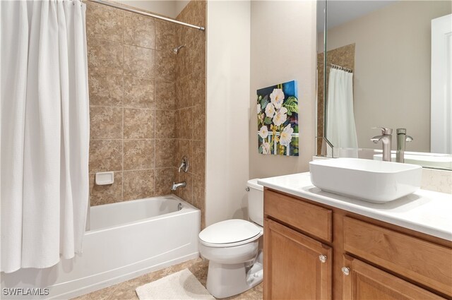 full bathroom with toilet, shower / bath combo, vanity, and tile patterned floors