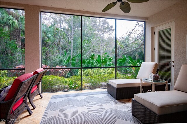 sunroom / solarium featuring ceiling fan