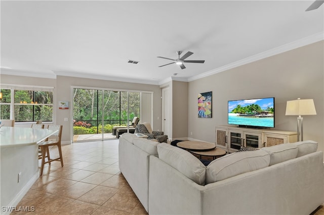 tiled living room featuring ornamental molding and ceiling fan